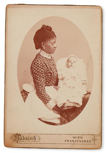 (PHOTOGRAPHY.) Black nanny with a white toddler.